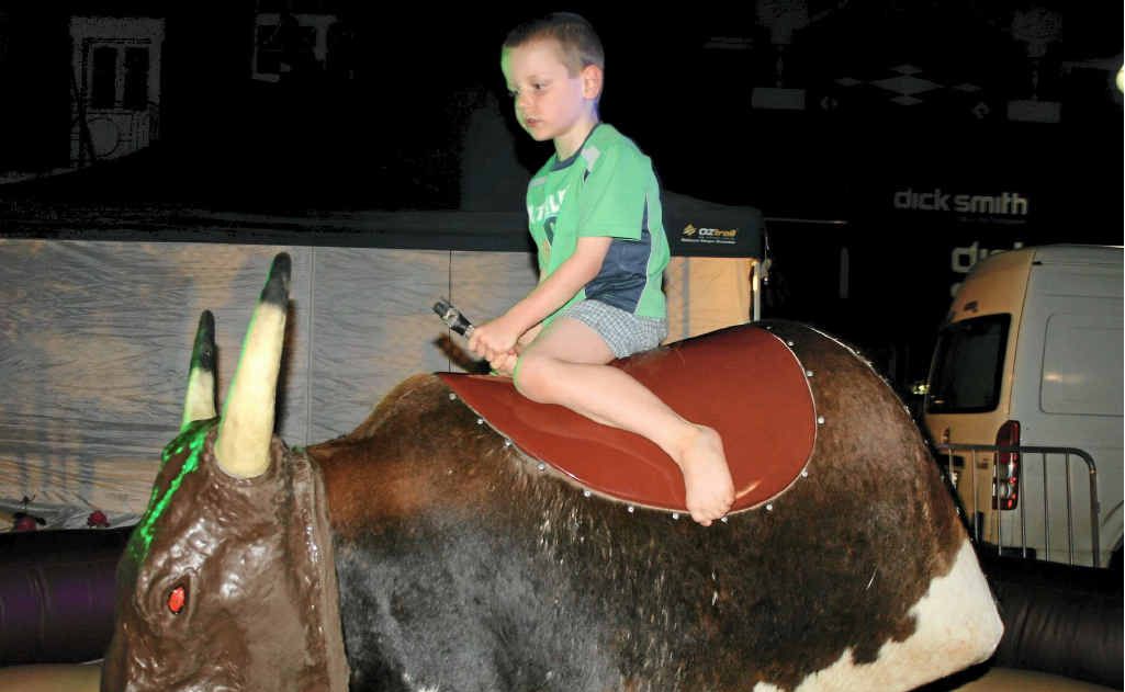 Chris Paroz tries his luck on the mechanical bucking bull at the Mardi Gras.